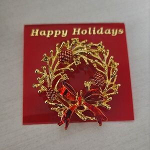 Vintage gold tone wreath brooch pin with red bow
